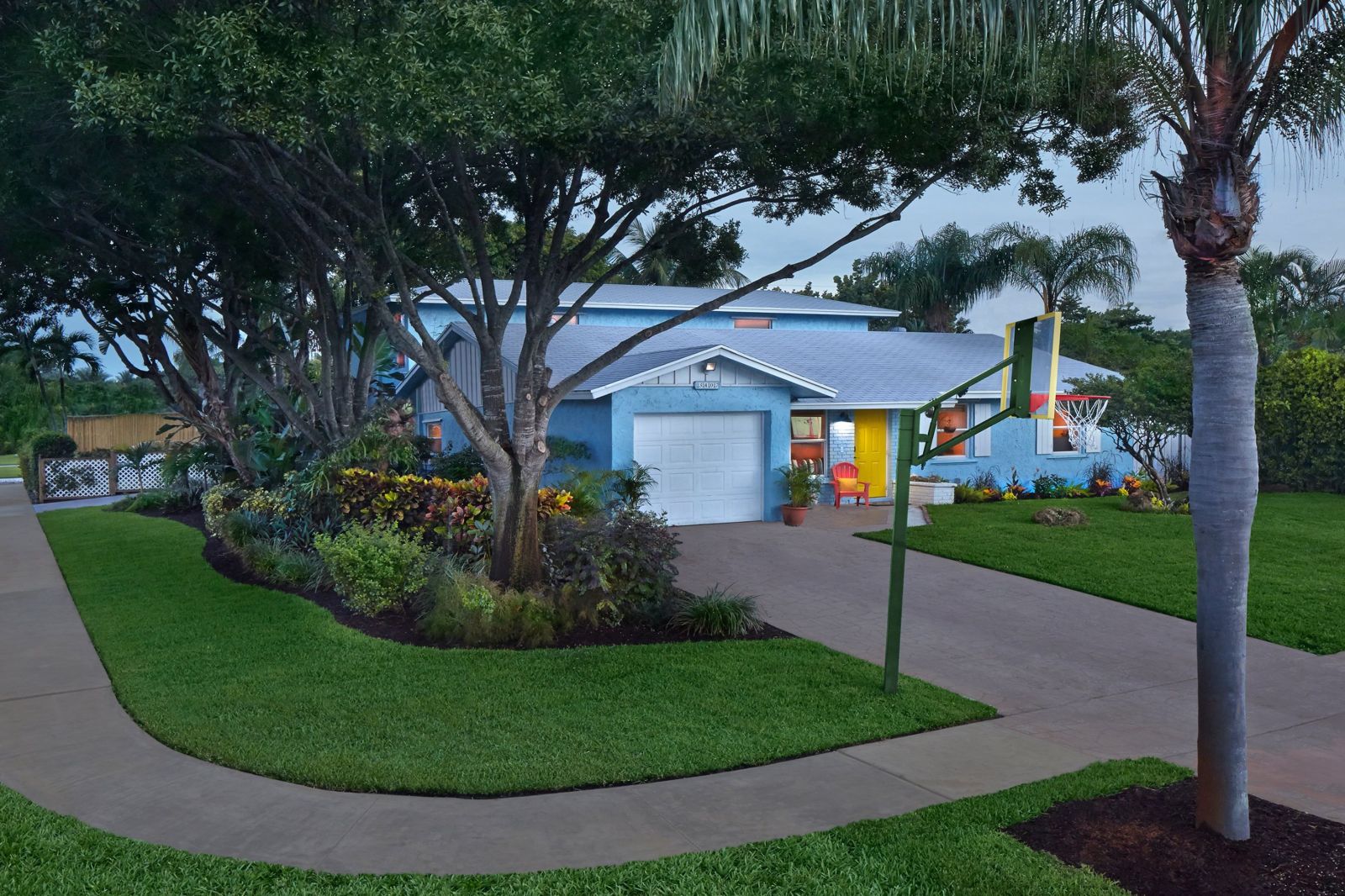 Front of an Addison House home with tropical landscaping